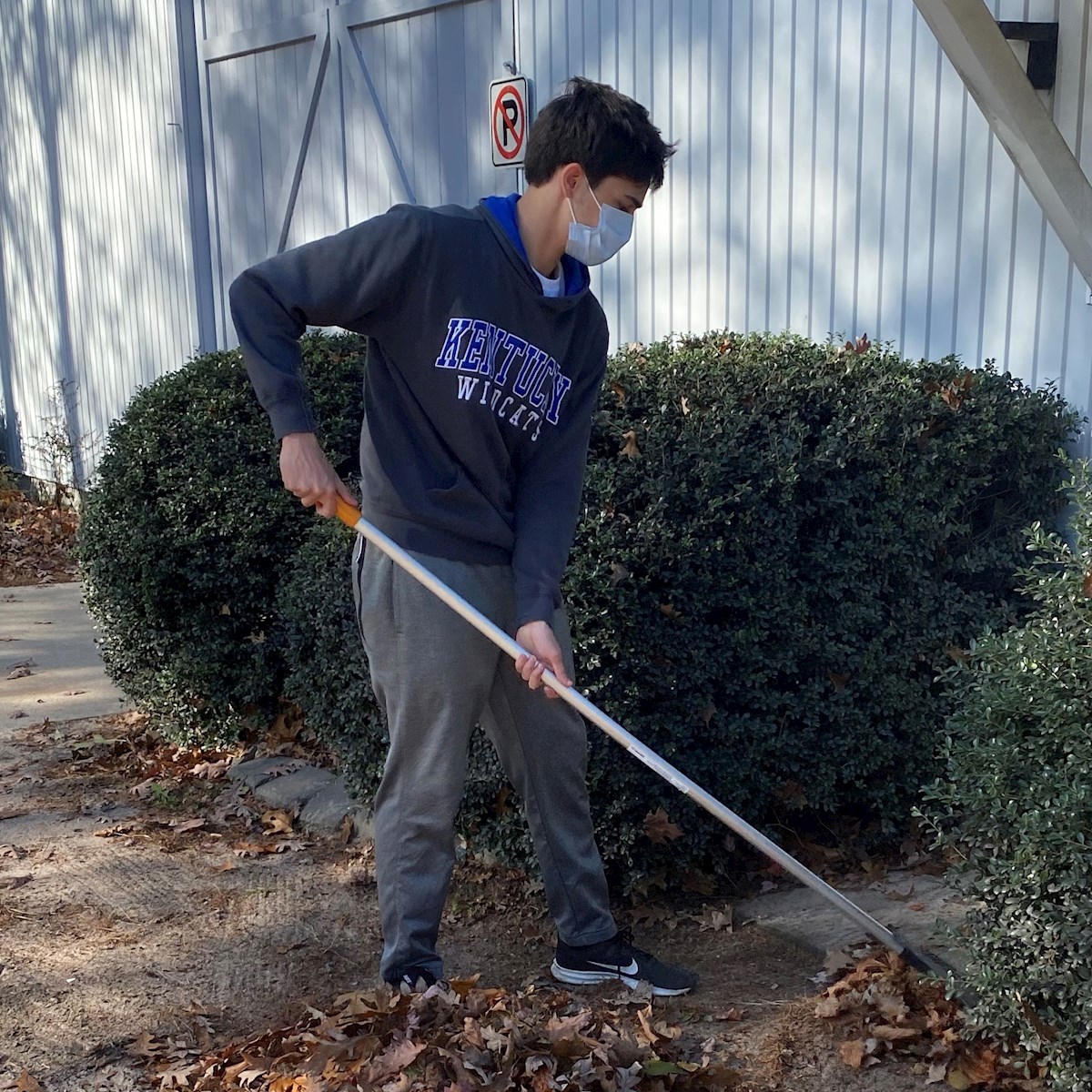 Prout Student Raking Leaves for Habitat